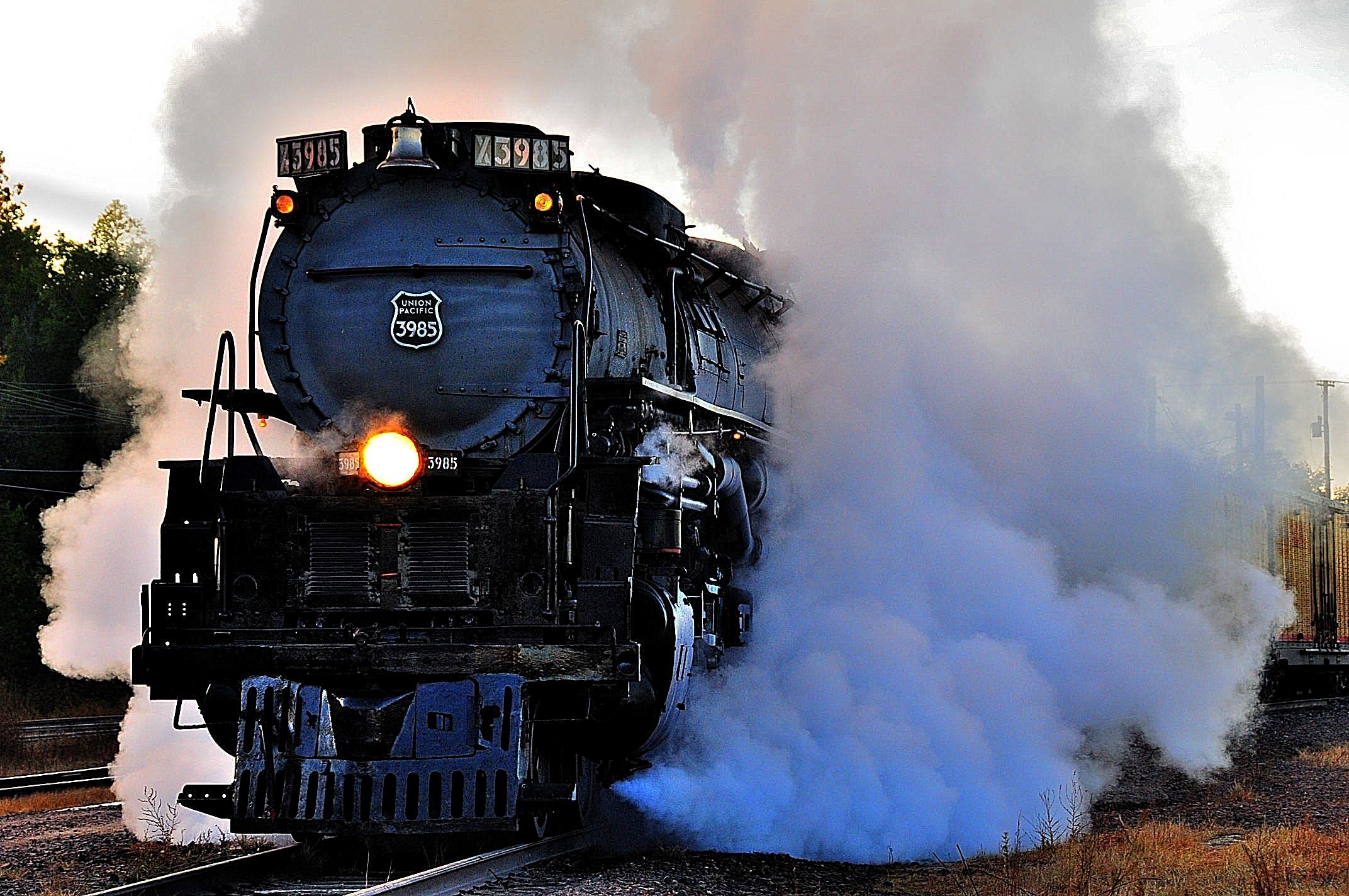 Train engine with a large cloud of smoke/steam coming from the train